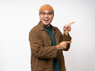 Handsome young man age smiling and happy pointing copy space. Charming male standing with on isolated white background. Asian people pose  with white backdrop.