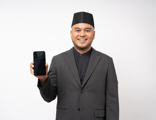 Muslim asian man standing using smartphone on isolated white background. Happy Portrait of cheerful smiling islamic asian man holding cell phone. People and lifestyle