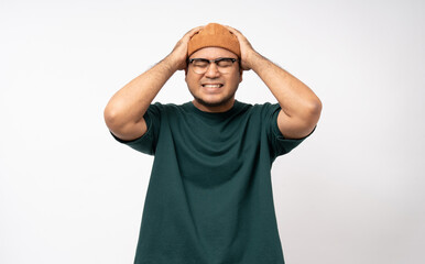 Handsome asian young man standing headache on isolated white background. Portrait of serious depressed asian man. People and lifestyle
