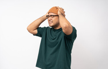 Handsome asian young man standing headache on isolated white background. Portrait of serious depressed asian man. People and lifestyle