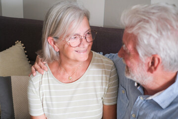 Senior couple in their 70s sharing loving and tender moments at home. A heartwarming scene of...