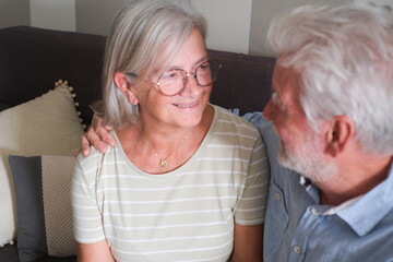 Senior couple in their 70s sharing loving and tender moments at home. A heartwarming scene of...