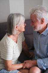 Senior couple in their 70s sharing loving and tender moments at home. A heartwarming scene of lasting love, emotional connection, companionship, and the joy of growing old together