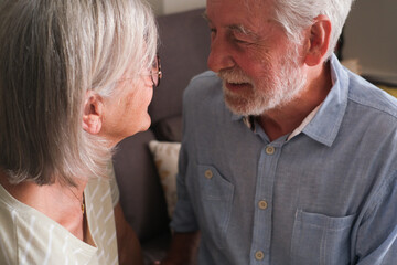 Senior couple in their 70s sharing loving and tender moments at home. A heartwarming scene of...