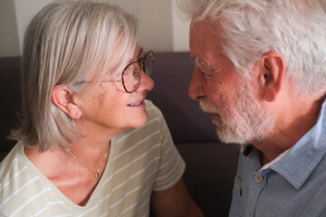 Senior couple in their 70s sharing loving and tender moments at home. A heartwarming scene of...