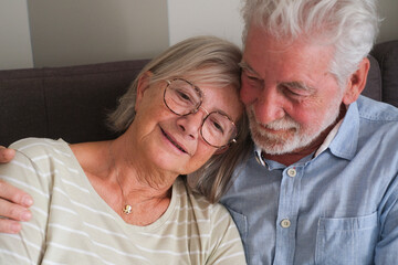 Senior couple in their 70s sharing loving and tender moments at home. A heartwarming scene of...