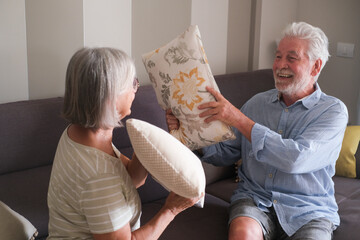 Senior couple in their 70s sharing loving and tender moments at home. A heartwarming scene of...