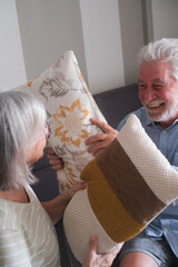 Senior couple in their 70s sharing loving and tender moments at home. A heartwarming scene of...