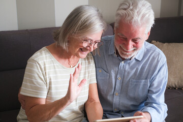 Senior couple in their 70s sharing loving and tender moments at home. A heartwarming scene of...