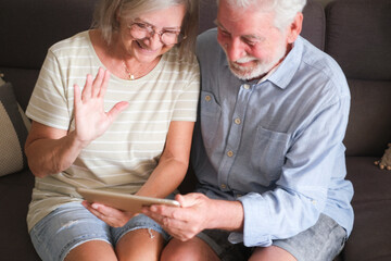Senior couple in their 70s sharing loving and tender moments at home. A heartwarming scene of...