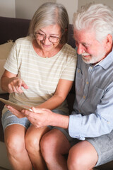 Senior couple in their 70s sharing loving and tender moments at home. A heartwarming scene of...