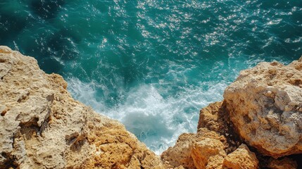 Ocean waves crashing on rocky cliff edge