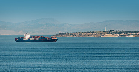 Container ship passing through the Dardanelles Strait near Gallipoli Peninsula, Turkey