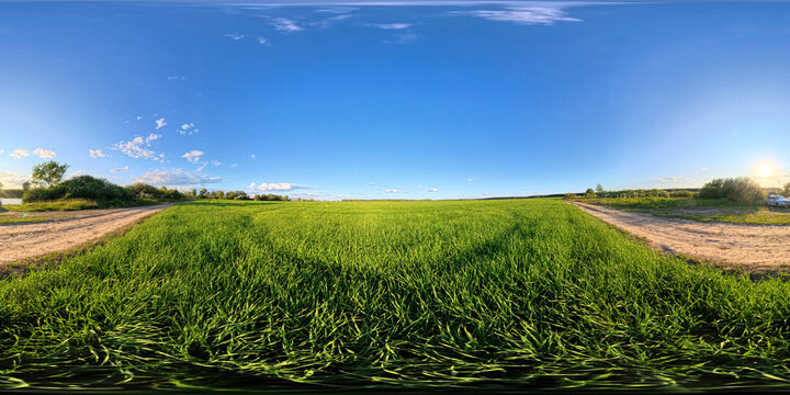 360 HDRI panoramic rural scene with grassy field, dirt roads and sunset light. Ideal for realistic lighting in 3D rendering, background wrap environments and open landscape simulations.