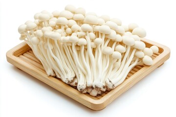Wooden tray with enoki mushrooms, isolated on a white background.