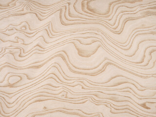 Flowing contours of plywood waves in a delicate dance of light and shadow across this plywood veneer