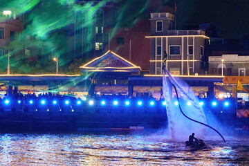 A light show and a jet ski flyboard performance were held at night in Xincun, Wanjiang, Dongguan,...