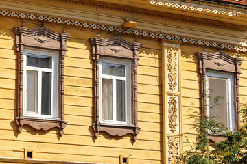 Ornate wooden architecture in tomsk, traditional carved facade with decorative windows