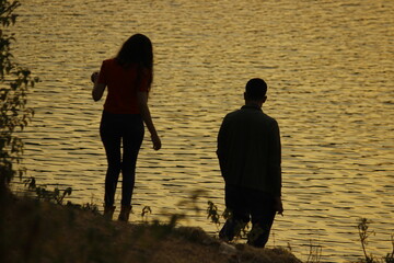 silhouette of a couple walking on the beach