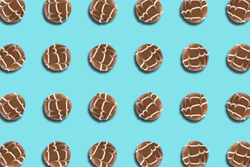 Top view of round milk chocolate pralines arranged in a regular pattern