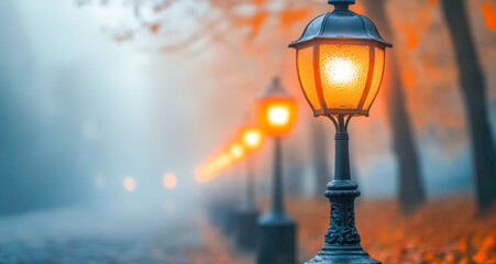 Warm glow of vintage street lamps on a foggy autumn evening