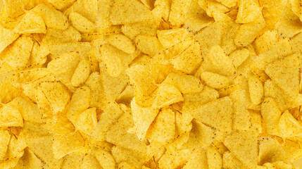 Obraz premium Heap of triangle corn chips pattern, food textured background
