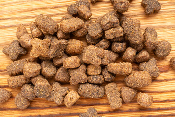 Dry pet food macro pieces, cat kibble closeup, dog pellets, small protein croquettes detailed