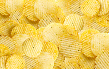 Corrugated chips wallpaper textured background, wavy potato chips pattern, crispy snack template