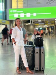 woman in airport. A young woman with suitcases at the airport