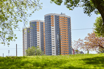 City street at spring in Kyiv, Ukraine. Trees against the backdrop of residential buildings