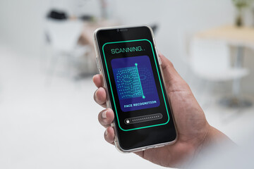 Security system with facial recognition, Face ID. Man unlocks smartphone with biometric identification scan, personal verification.