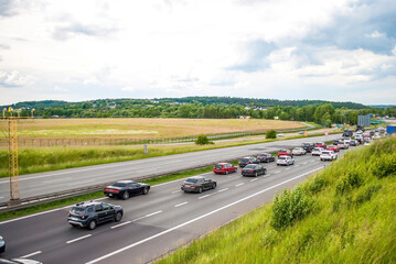 Many cars on the road. View from above. Traffic jams on the highway. Transport industry.