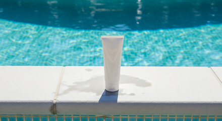 Tube of Sunscreen on Swimming Pool Edge in Sunny Outdoor Setting