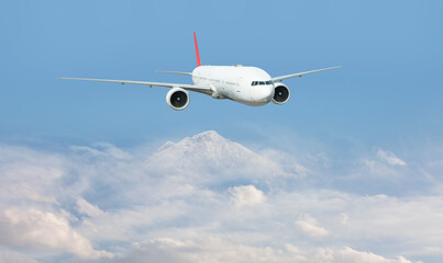 An airplane flying over a taurus mountain range, with snow-capped peaks visible below