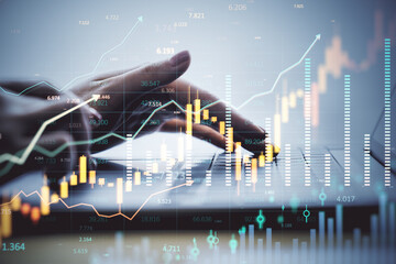 Businesswoman analyzing financial data on laptop with stock market charts and forex graphs overlayed in virtual fintech interface concept.