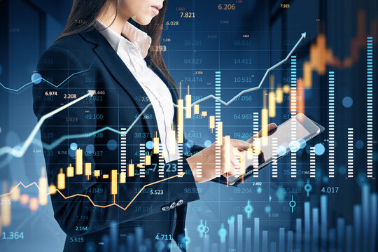 Businesswoman analyzing digital forex and stock market data on tablet with financial charts and graphs in futuristic virtual background concept.