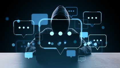 Anonymous hacker in hoodie surrounded by glowing speech bubbles and chat icons on dark digital...