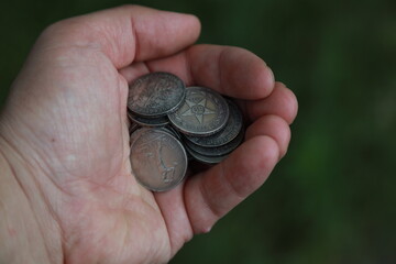 A pile of old Russian silver coins in hand