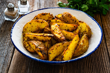Roasted potatoes on wooden table	