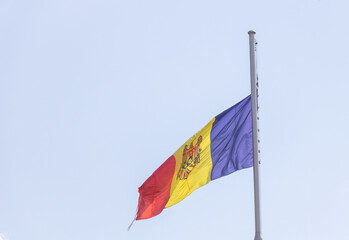 Moldovan national flag waving in the wind against clear blue sky