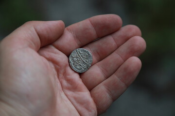 Medieval silver coin one rupee of India in hand