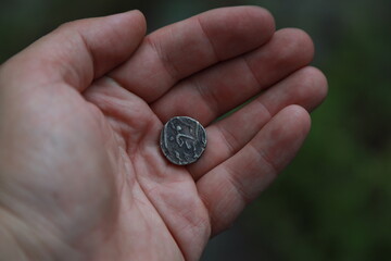 Medieval silver coin one rupee of India in hand