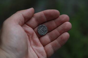 Medieval silver coin one rupee of India in hand