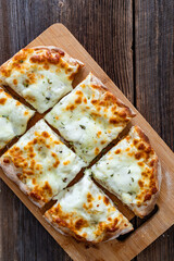Pinsa bianca white pizza with oregano on wooden table