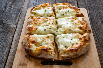 Pinsa bianca white pizza with oregano on wooden table	
