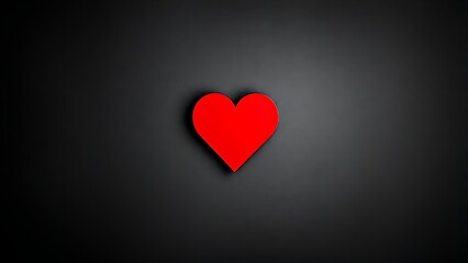 Bold red heart shape on a dark textured backdrop, conveying deep emotions and minimalist beauty.