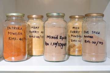 Variety of spice jars labeled with prices displayed in eco shop