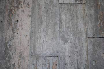 A close-up of the concrete wall texture, showcasing its rough and worn appearance with visible cracks and chips of paint