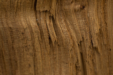 Pile of split firewood, ready for burning. Close-up of weathered wooden planks showing knots and...