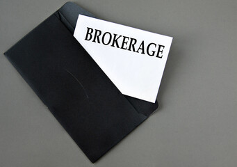 BROKERAGE - word on white paper on a black envelope with a magnifying glass